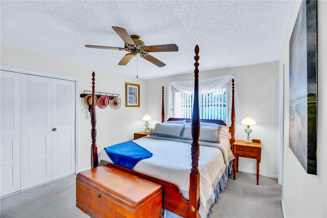 7666 134th Street Sebastian, FL 32958 - Photo 15 of 35 a bedroom with furniture and a chandelier