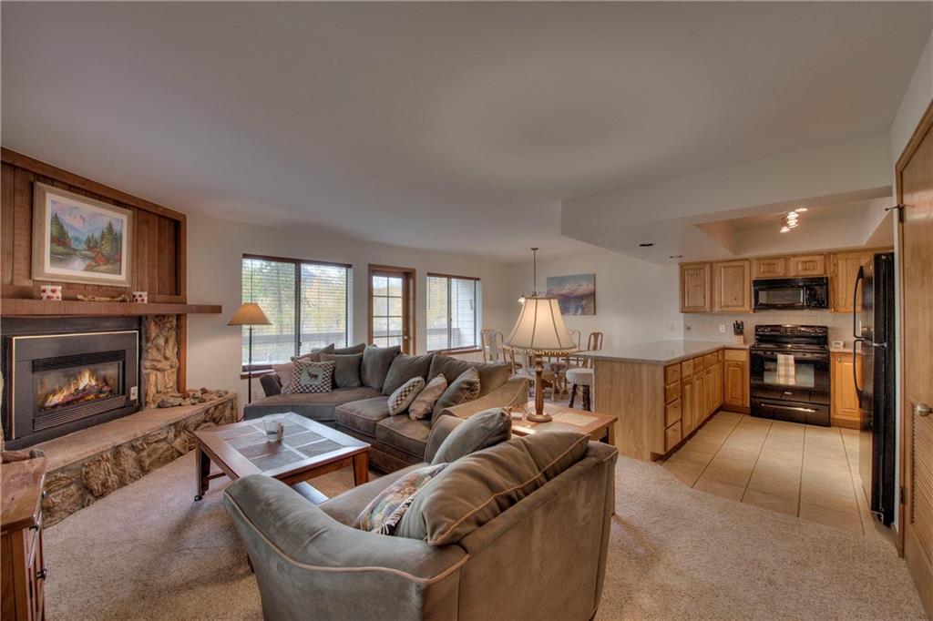 4811 Ryan Gulch Road, Unit 4811 Silverthorne, CO 80498 - Photo 11 of 35 a living room with furniture fireplace and flat screen tv