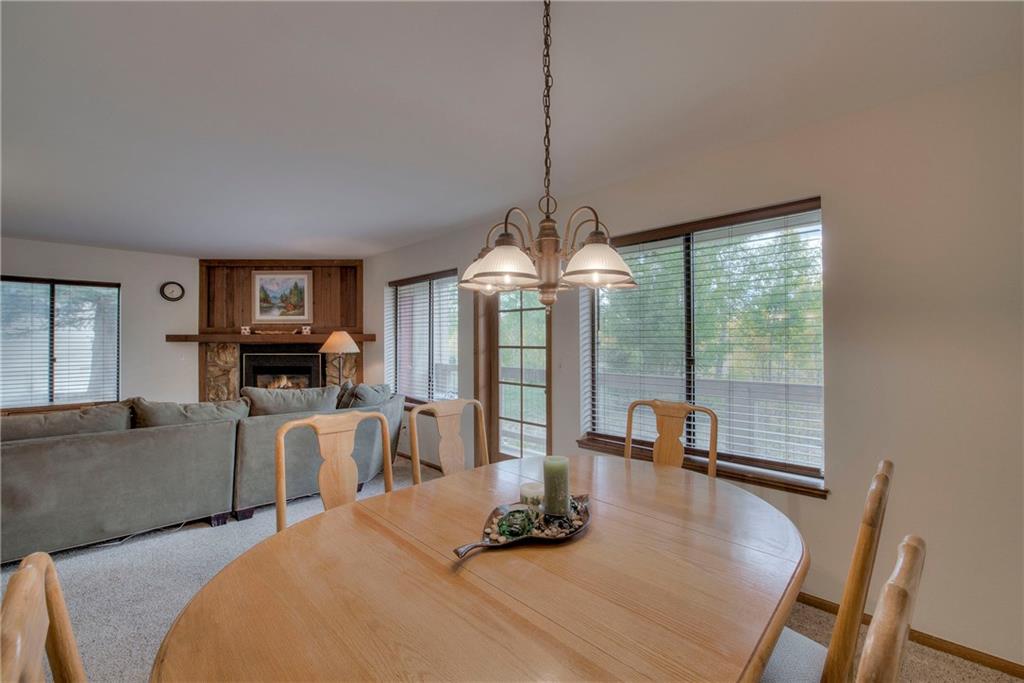 4811 Ryan Gulch Road, Unit 4811 Silverthorne, CO 80498 - Photo 14 of 35 a dining room with furniture mountain view and a chandelier