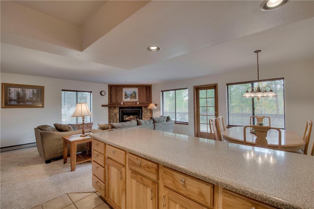 4811 Ryan Gulch Road, Unit 4811 Silverthorne, CO 80498 - Photo 15 of 35 a kitchen with granite countertop a sink and chairs