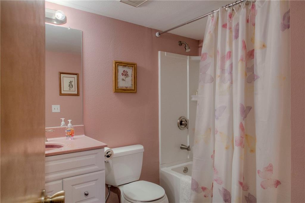 4811 Ryan Gulch Road, Unit 4811 Silverthorne, CO 80498 - Photo 18 of 35 a bathroom with a granite countertop toilet a sink and a shower