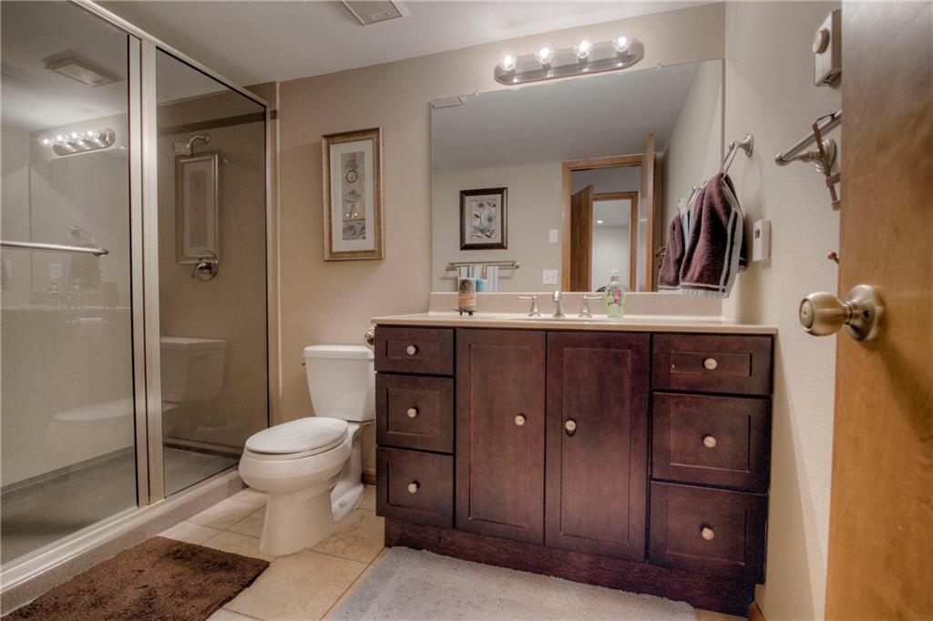 4811 Ryan Gulch Road, Unit 4811 Silverthorne, CO 80498 - Photo 20 of 35 a bathroom with a toilet a sink and shower