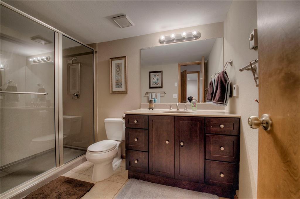 4811 Ryan Gulch Road, Unit 4811 Silverthorne, CO 80498 - Photo 6 of 35 a bathroom with a double vanity sink toilet and shower