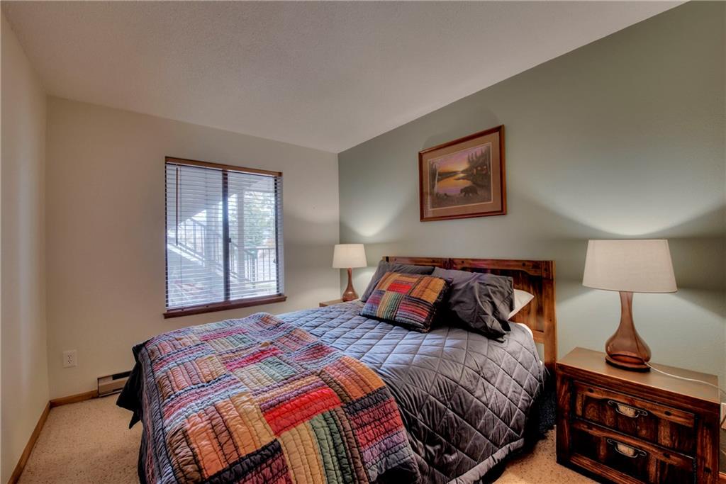 4811 Ryan Gulch Road, Unit 4811 Silverthorne, CO 80498 - Photo 7 of 35 a bedroom with a bed and wooden floor