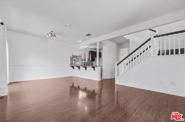 a view of an entryway with wooden floor