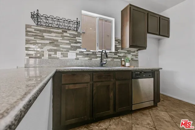 a kitchen with a sink and a mirror