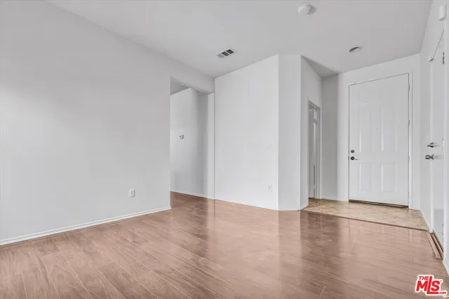 a view of a room with wooden floor