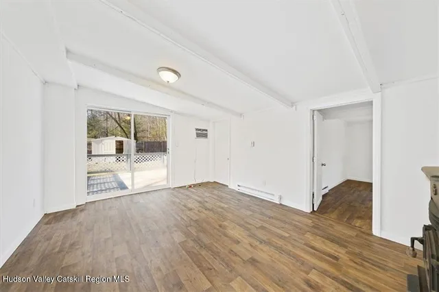 a view of an empty room and glass door