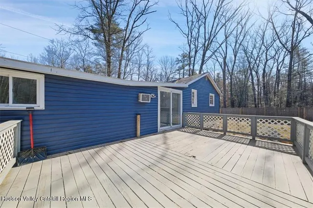 a view of backyard with a deck and wooden floor