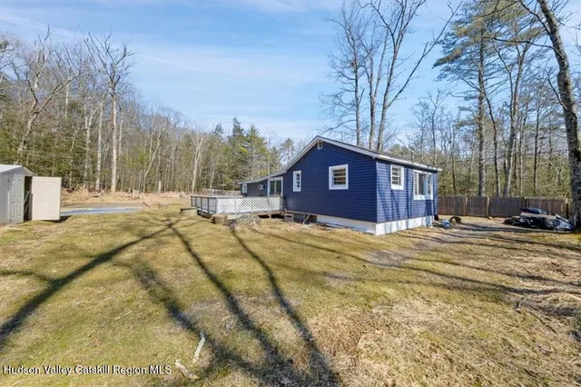 a view of a house with a yard covered in snow