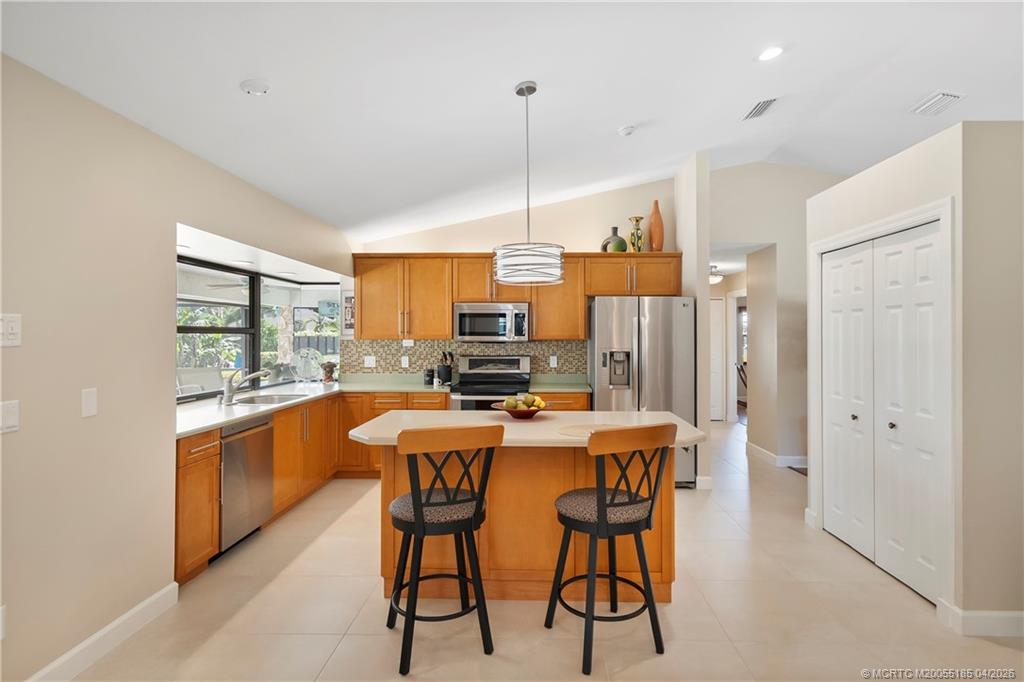 4620 Southeast Quail Trail Stuart, FL 34997 - Photo 15 of 71 a large kitchen with a table and chairs