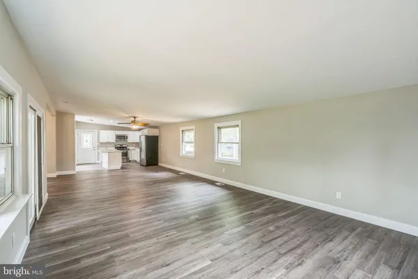 a view of a livingroom with wooden floor and a window