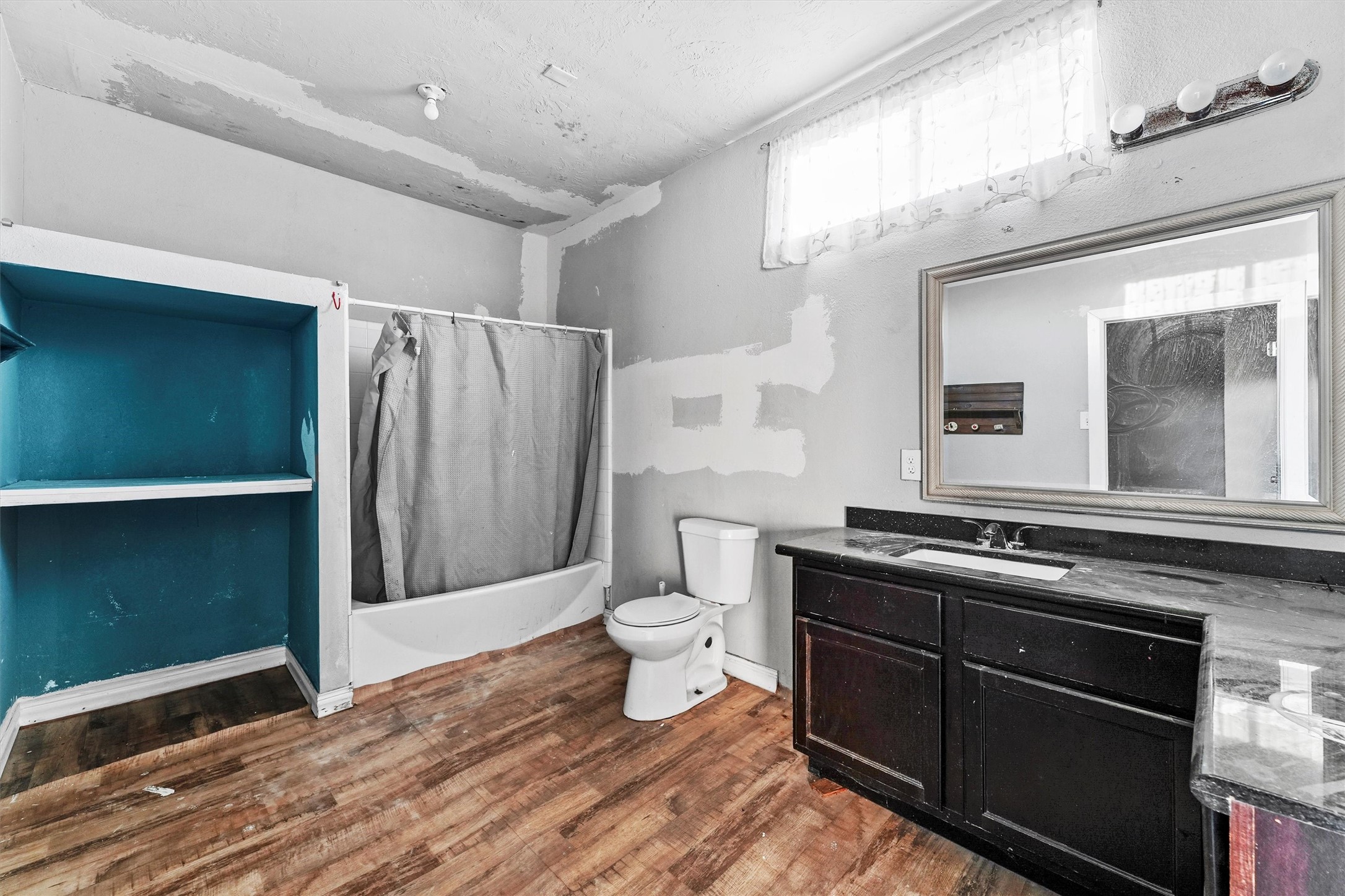 4322 Bennington Street Houston, TX 77016 - Photo 18 of 26 a bathroom with a sink a toilet a mirror and shower