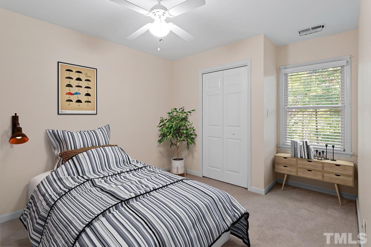 106 Keystone Drive Cary, NC 27513 - Photo 28 of 43 a bedroom with a bed and a chandelier