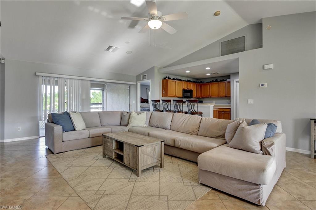314 Rand Avenue Lehigh Acres, FL 33974 - Photo 6 of 35 a living room with furniture and a view of kitchen