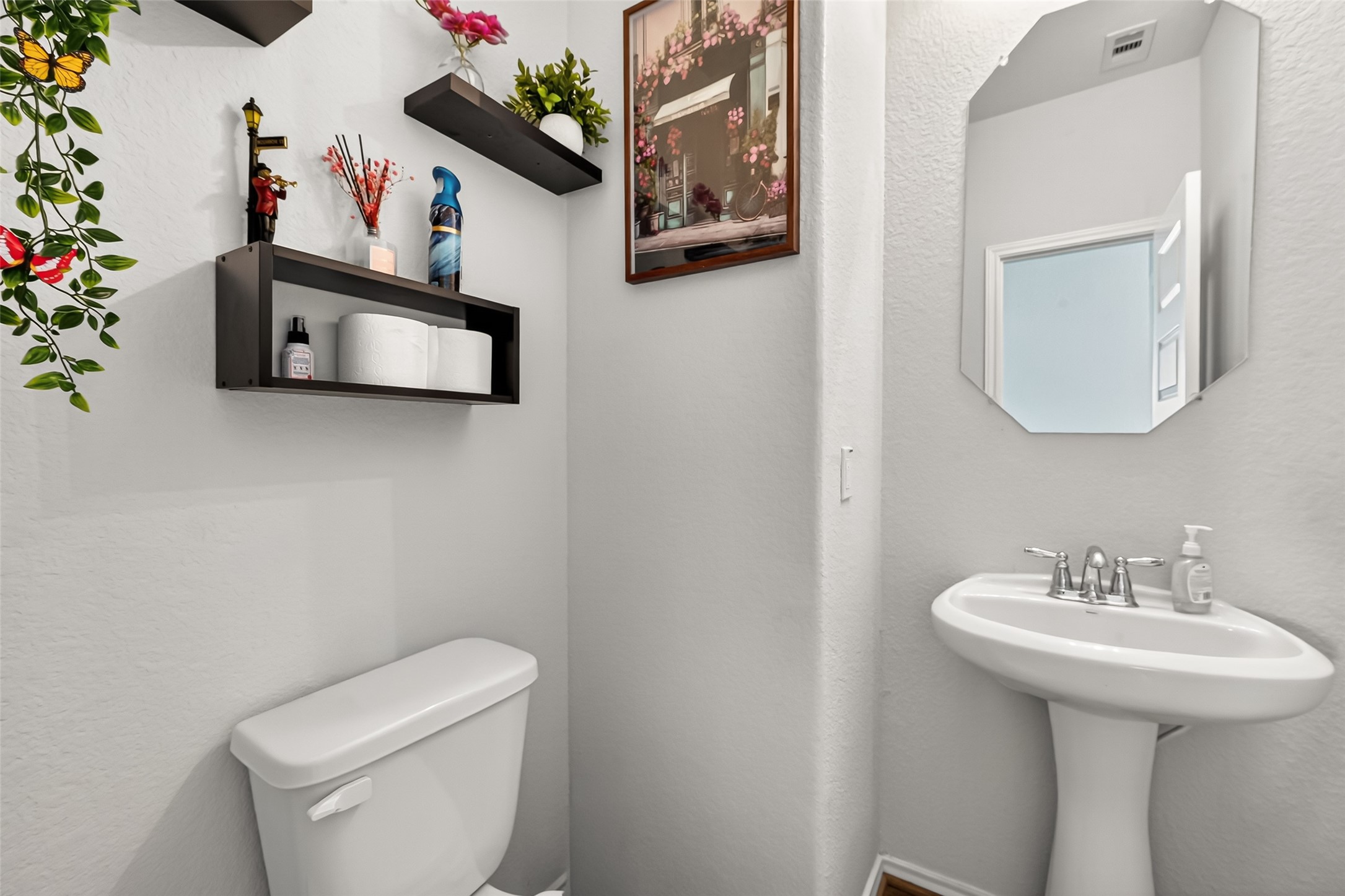 1601 Darwin Cedar Drive Rosharon, TX 77583 - Photo 12 of 44 a bathroom with a toilet a sink and mirror