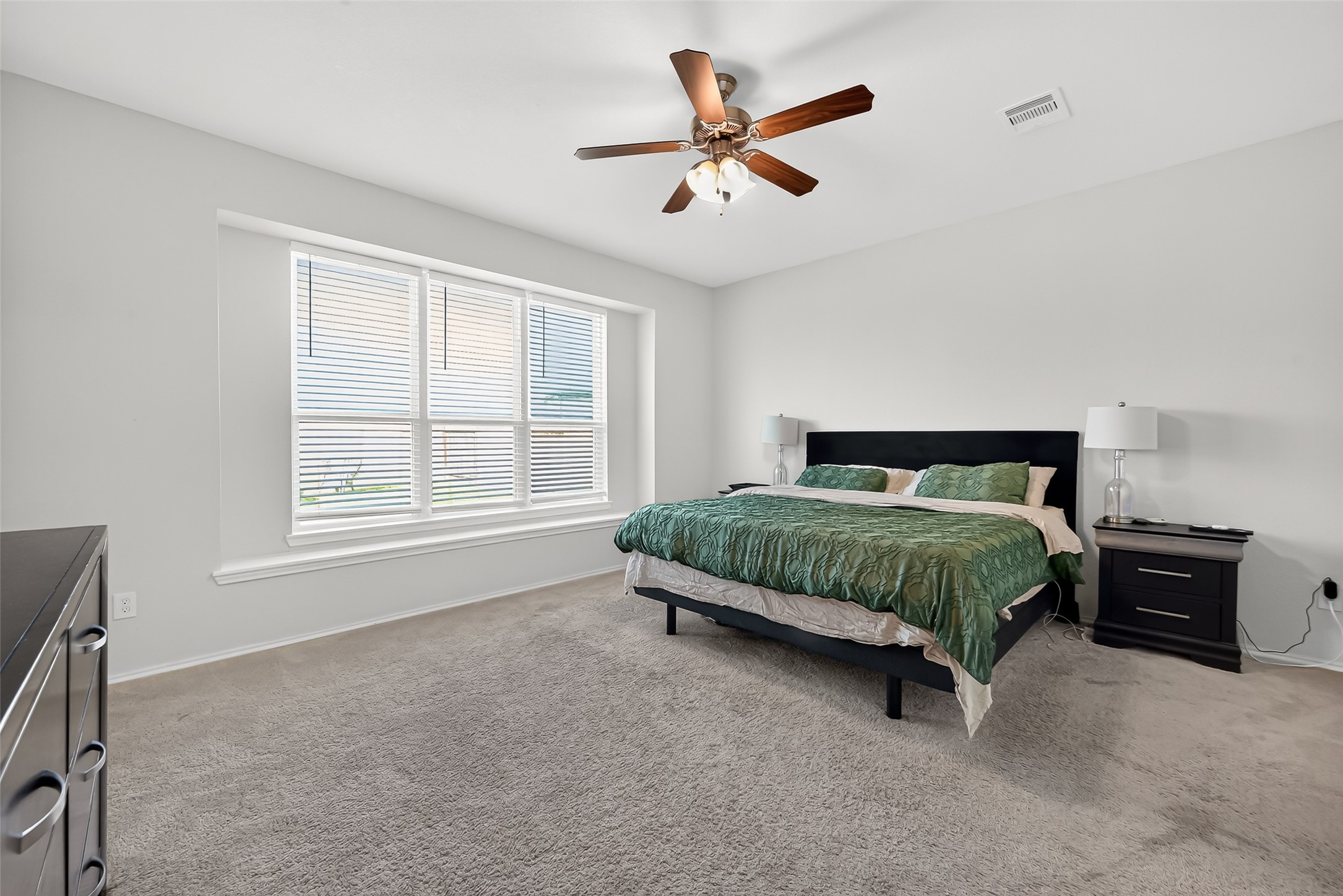 1601 Darwin Cedar Drive Rosharon, TX 77583 - Photo 34 of 44 a bedroom with a bed a window and a chandelier