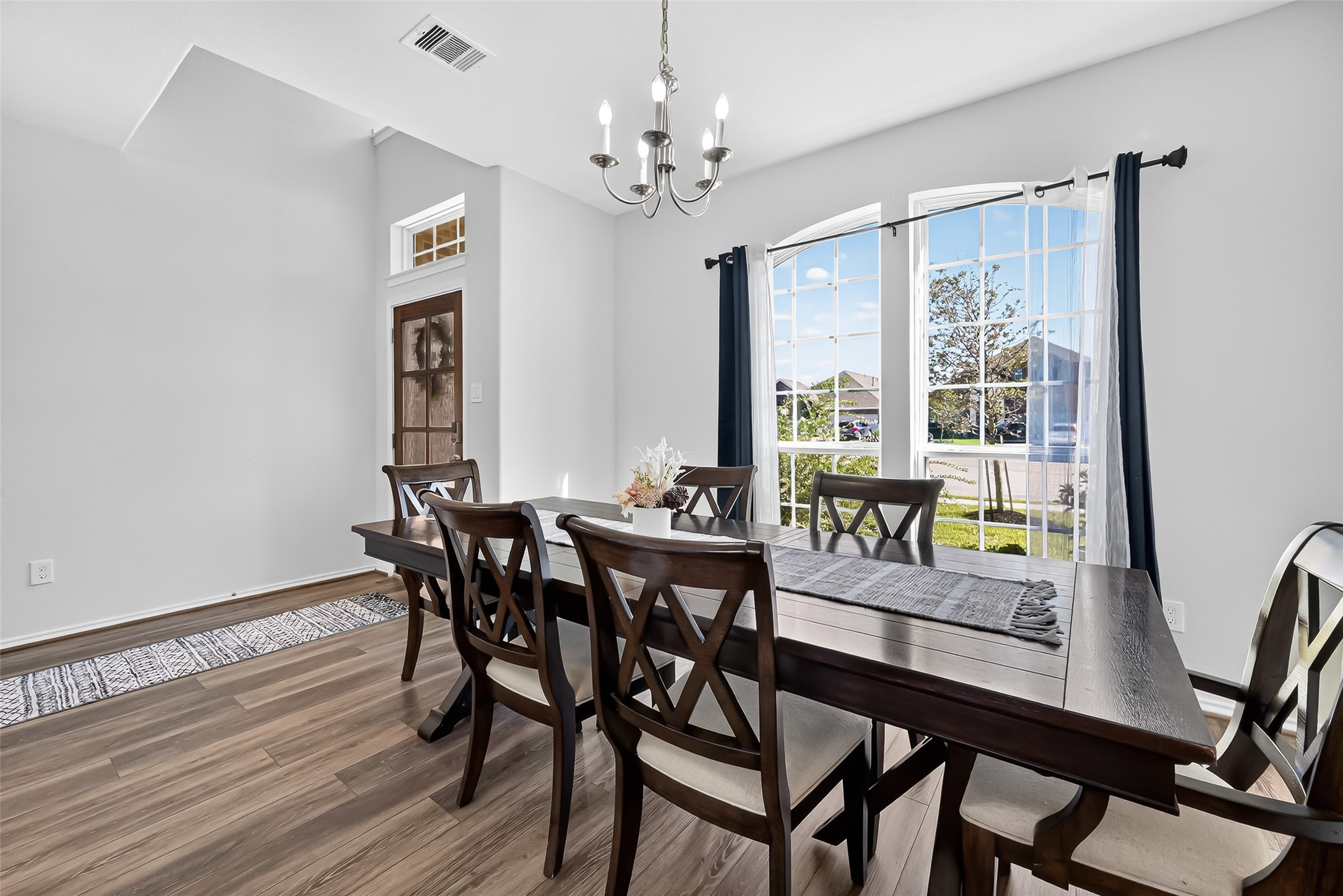 1601 Darwin Cedar Drive Rosharon, TX 77583 - Photo 7 of 44 a dining room with furniture a rug and a chandelier