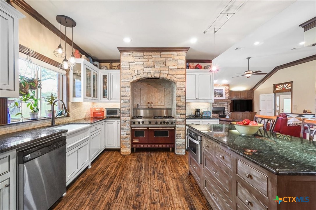 615 Benchmark Trail Belton, TX 76513 - Photo 13 of 36 a kitchen with stainless steel appliances granite countertop a stove and a sink