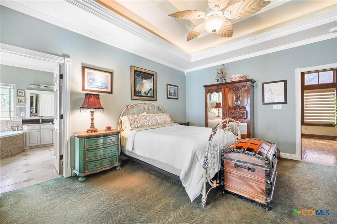 615 Benchmark Trail Belton, TX 76513 - Photo 21 of 36 a bedroom with bed and a chandelier