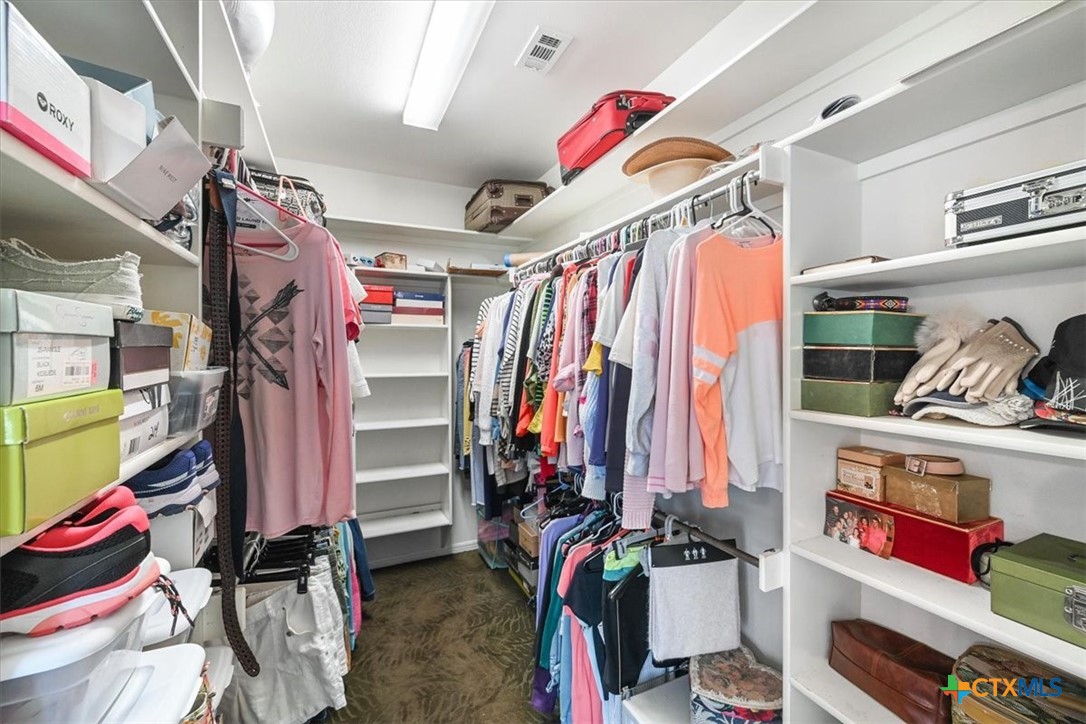 615 Benchmark Trail Belton, TX 76513 - Photo 25 of 36 a view of walk in closet with clothes and shoes