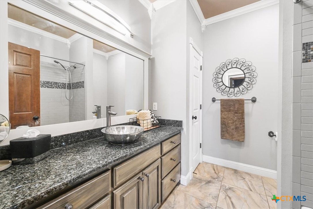 615 Benchmark Trail Belton, TX 76513 - Photo 26 of 36 a bathroom with a granite countertop sink and a mirror