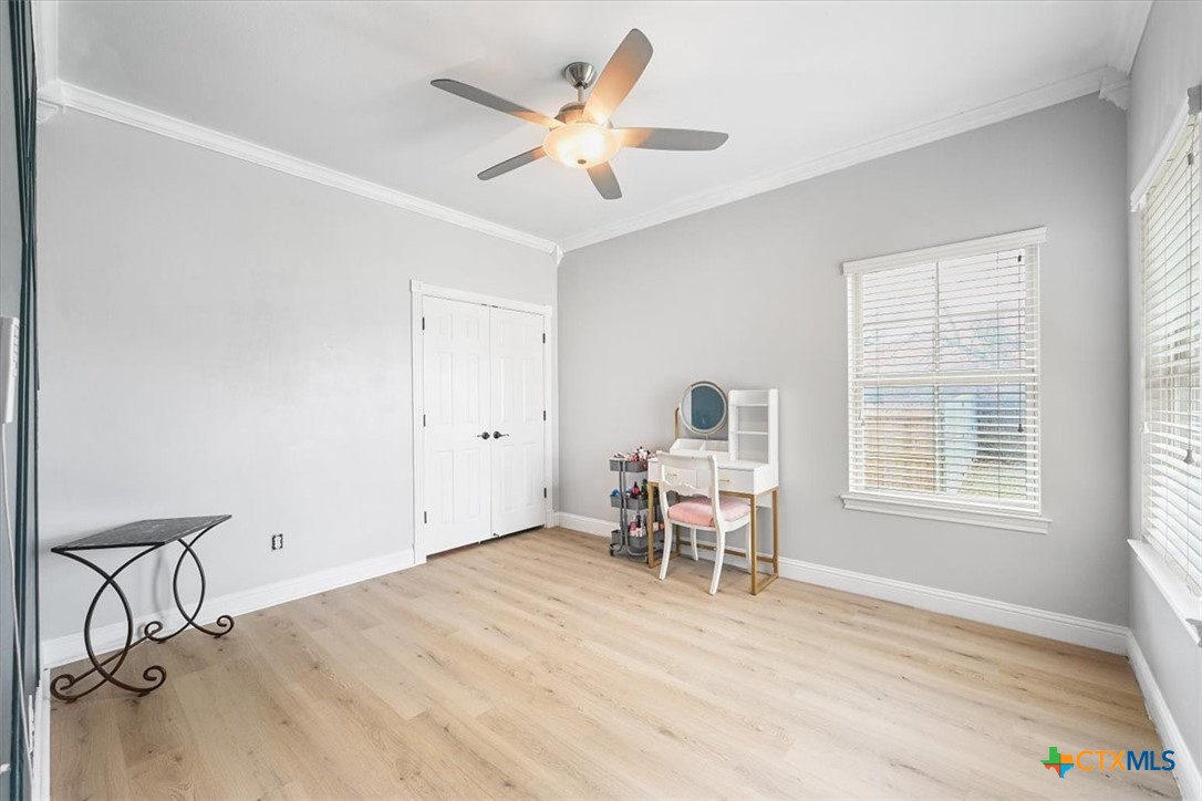 615 Benchmark Trail Belton, TX 76513 - Photo 27 of 36 a view of a work space with wooden floor and a ceiling fan