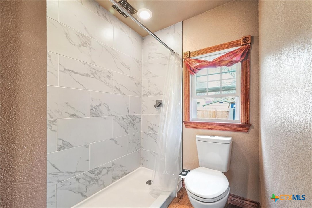 615 Benchmark Trail Belton, TX 76513 - Photo 33 of 36 a white toilet sitting next to a shower