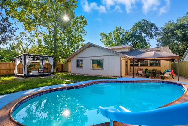 a view of a house with swimming pool and sitting area