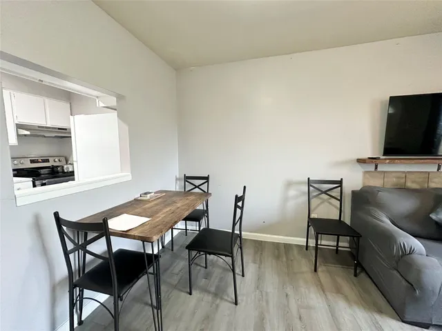 a view of a dining room with furniture and wooden floor