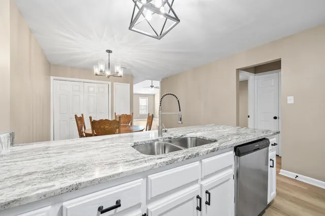 a kitchen with a sink and chandelier