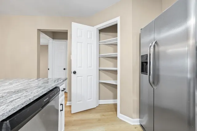 a view of cabinets and refrigerator