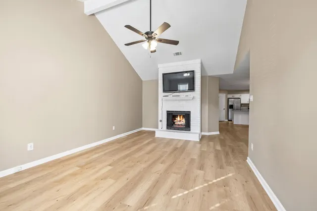 a view of an empty room with a fireplace