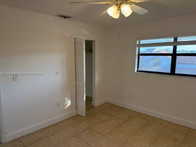 12960 Southwest 66th Lane, Unit 1031 Miami, FL 33183 - Photo 7 of 7 an empty room with a chandelier fan and wooden floor