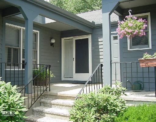 29 Fawn Ridge Lane, Unit 29 Wilton, CT 06897 - Photo 1 of 1 a front view of a house with a porch