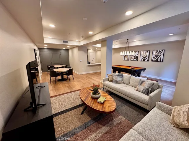 a kitchen with a sink a counter top space stainless steel appliances and cabinets