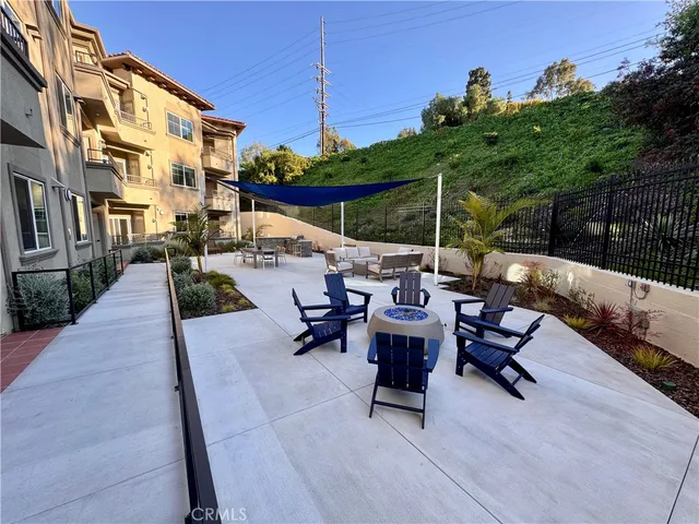 a view of a patio with a table and chairs