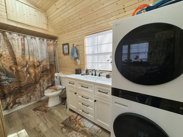 a bathroom with a sink toilet and shower