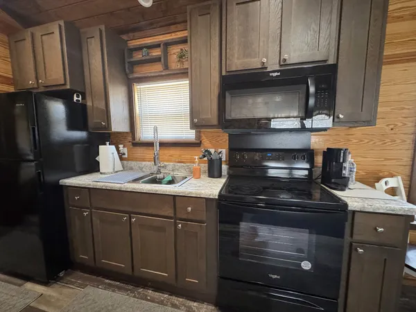 a kitchen with stainless steel appliances granite countertop a stove and a microwave