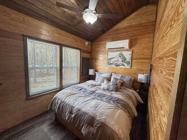 a bedroom with a large bed and a window