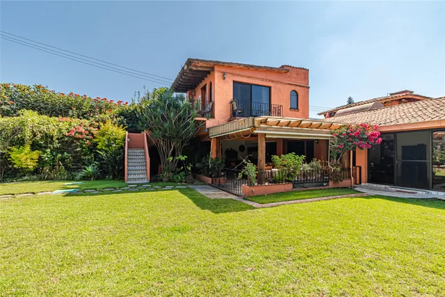 a view of a house with swimming pool and sitting area