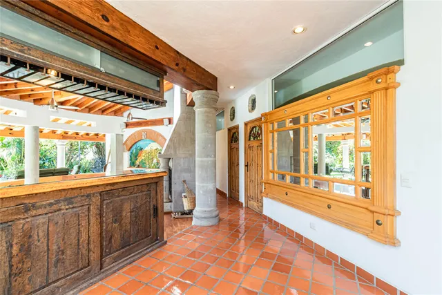 a view of a porch with wooden floor and furniture