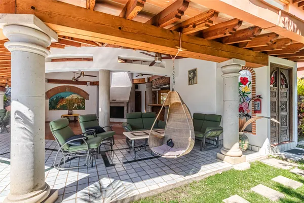 a view of a chairs and table in backyard