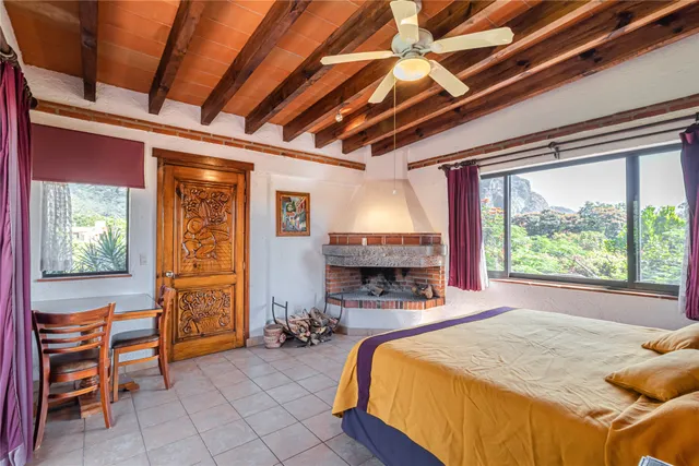 a bed room with a bed and a chair