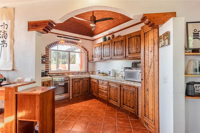a kitchen with stainless steel appliances granite countertop a sink and cabinets
