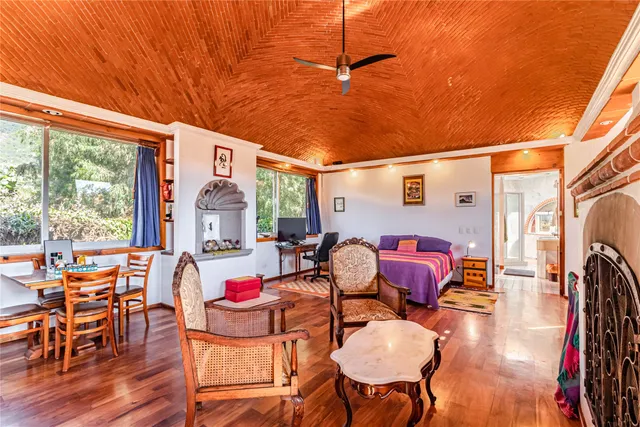 a dining room with furniture and wooden floor