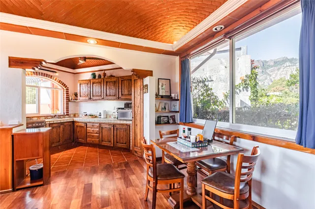 a dining room with a large window table and chairs