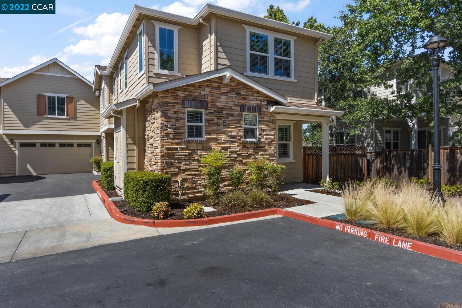a view of a house with a small yard and plants