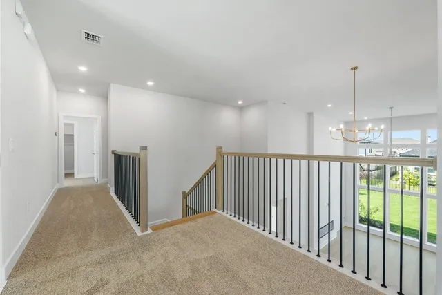 a view of an empty room with a kitchen