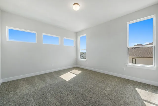 a view of a house with a yard and potted plants